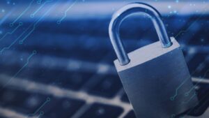 A padlock sits on a laptop keyboard